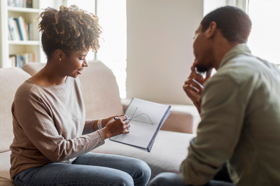 Black female therapist counseling black male client in a psychiatric rehabilitation program for substance abuse and mental health treatment