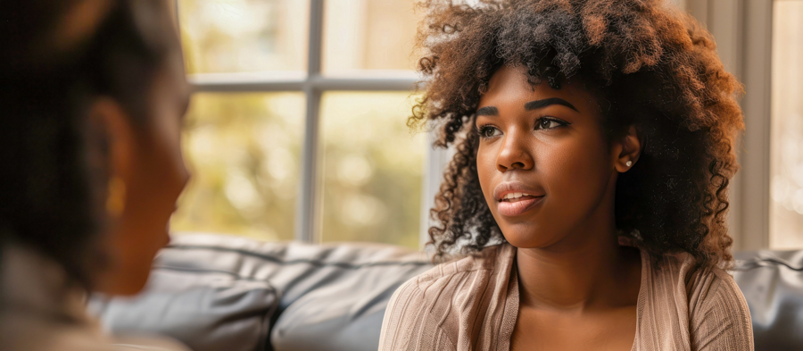black woman receiving motivational interviewing from black female therapist