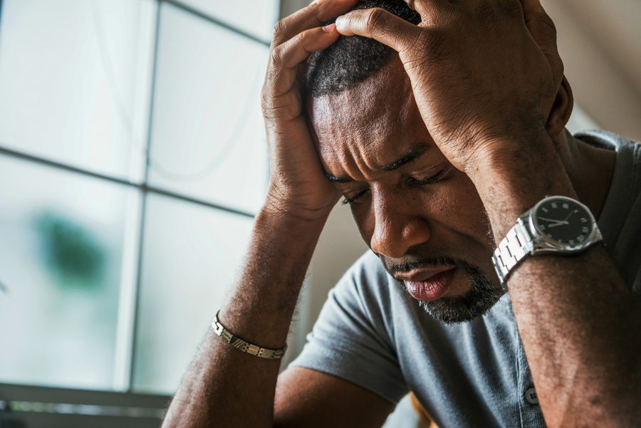black man feeling depressed while battling substance abuse and mental illness